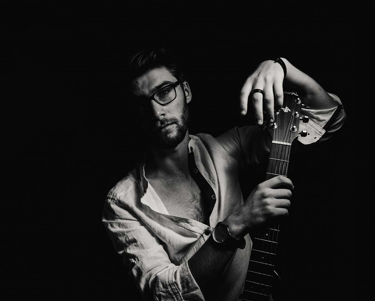 guitar grayscale photo of man holding guitar black-and-white