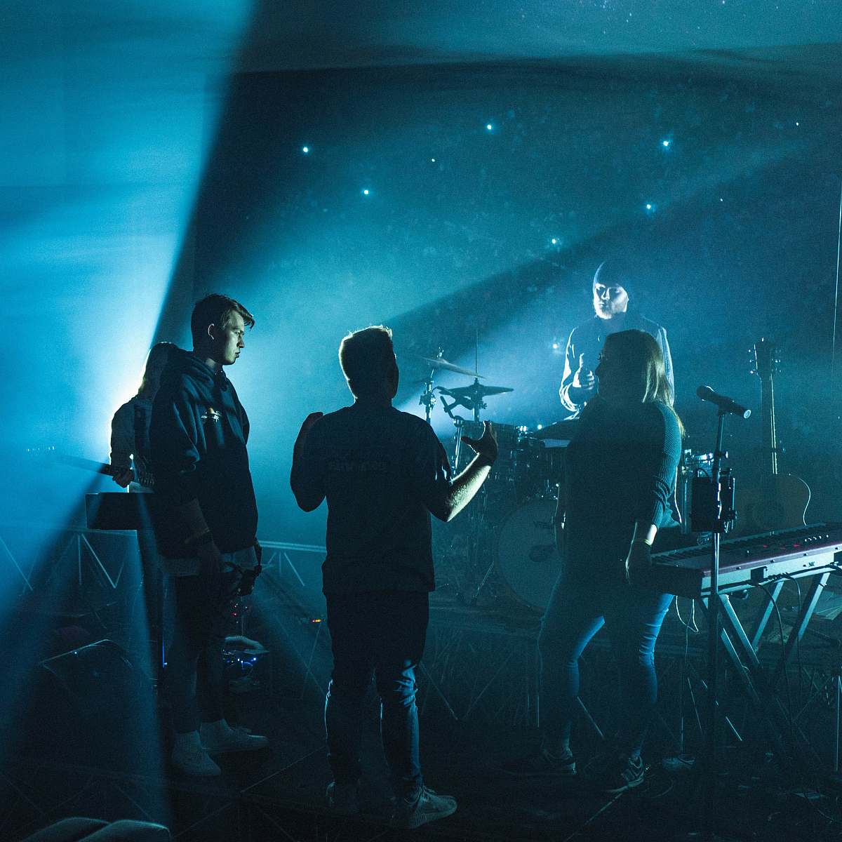 human group of band members having discussion on stage people