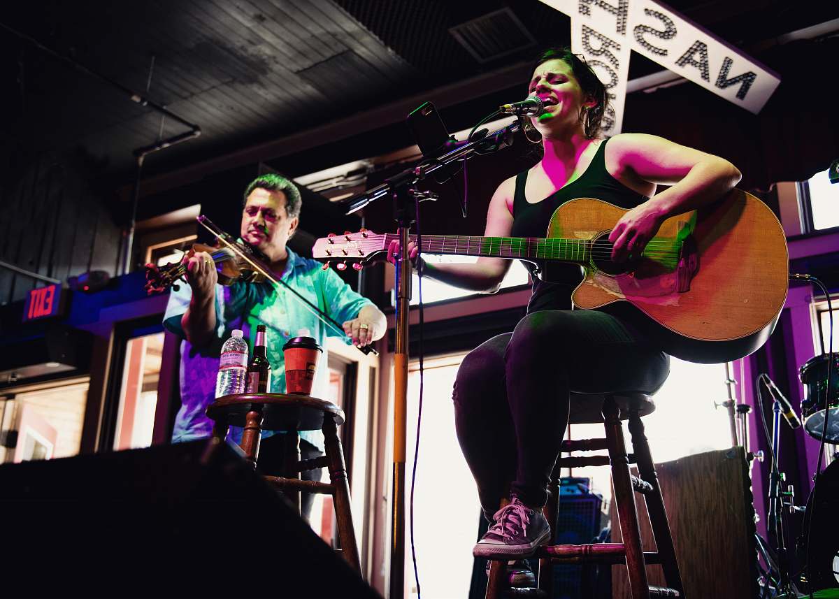human man and woman playing musical instruments guitar