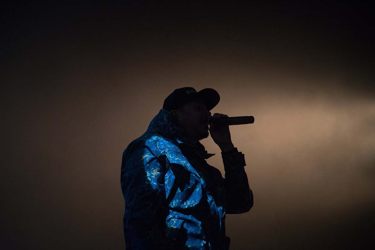 human man holding microphone low light photography music