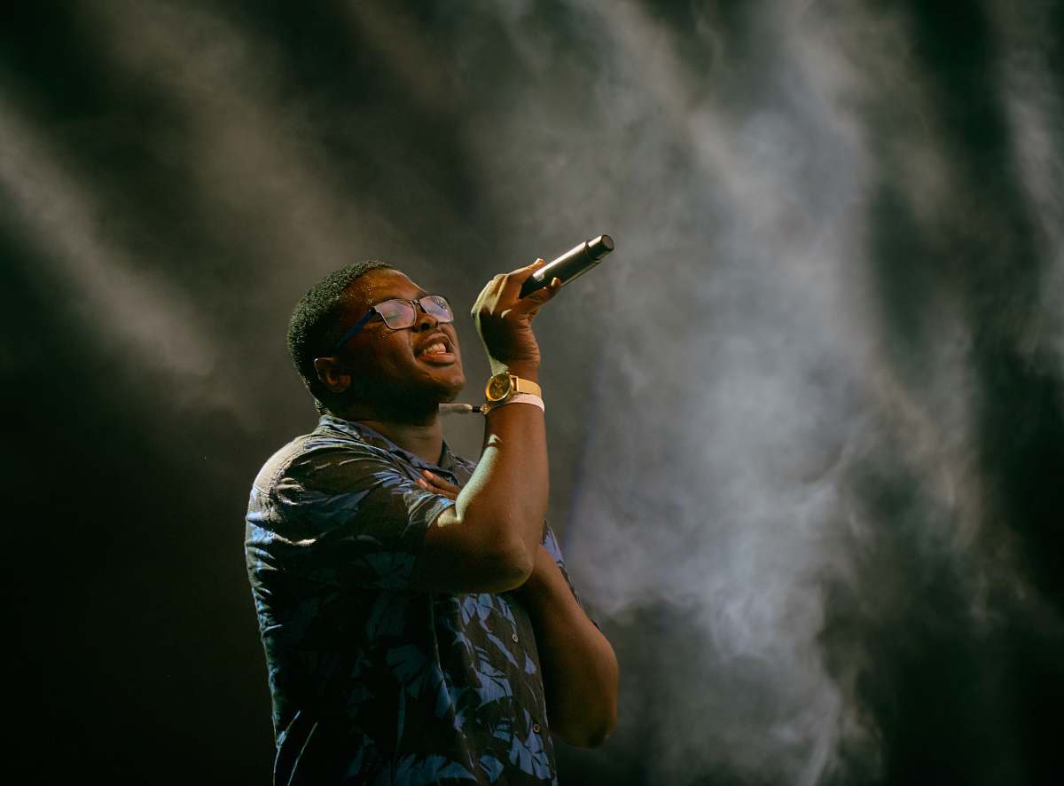 human man holding microphone singing people