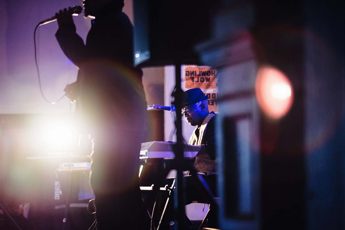human man holding microphone while singing people