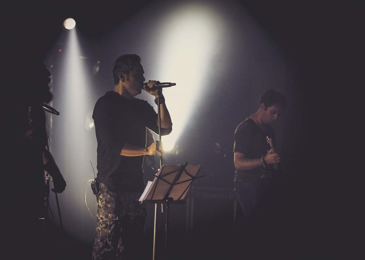human man in black t-shirt singing musician