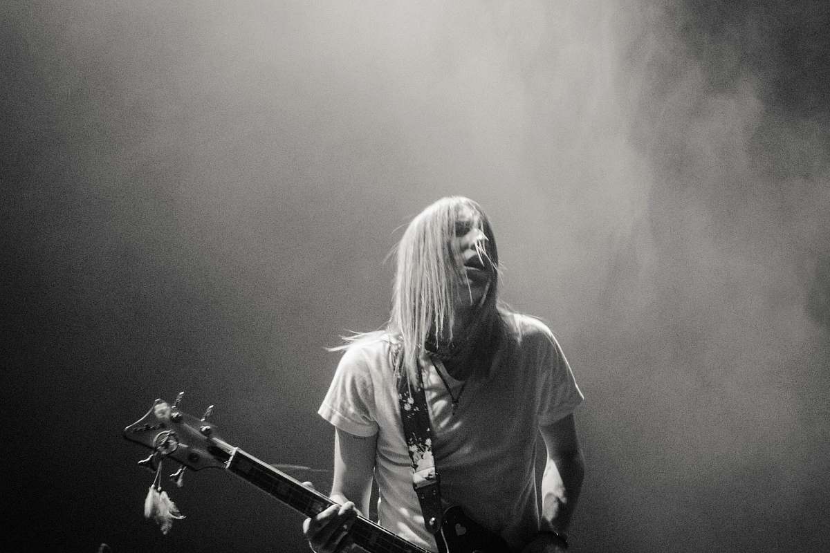 human man playing electric guitar black-and-white