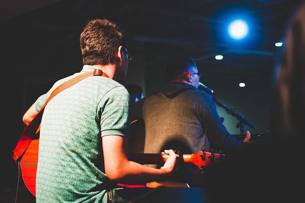 human man playing guitar people