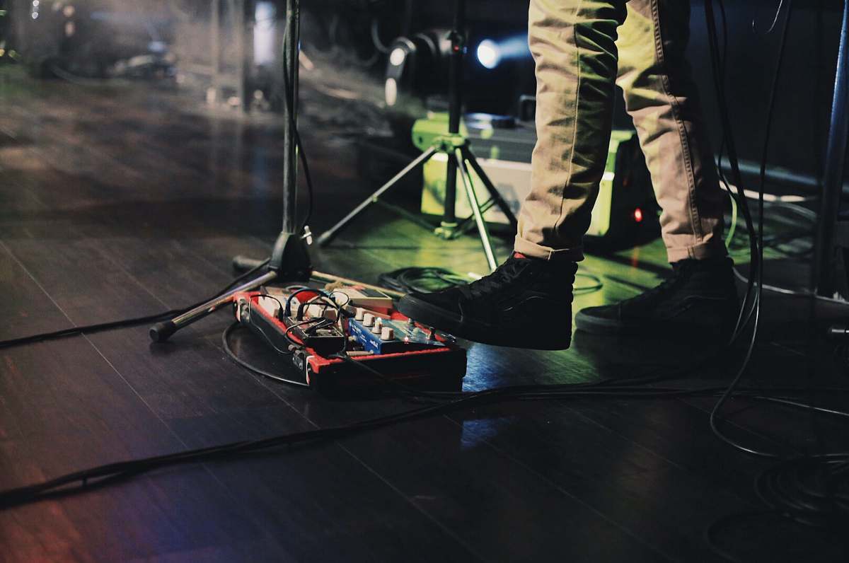 people man playing red musical instrument on stage human