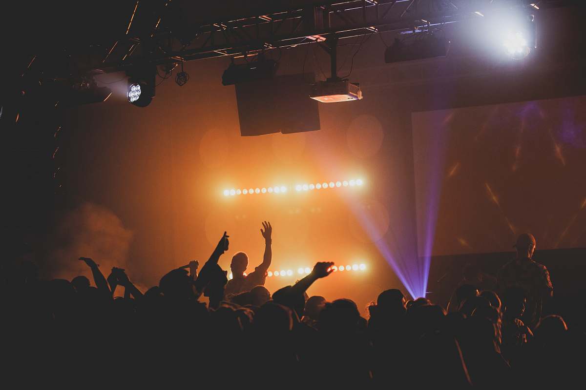 astronomy man raising right hand facing crowd outer space