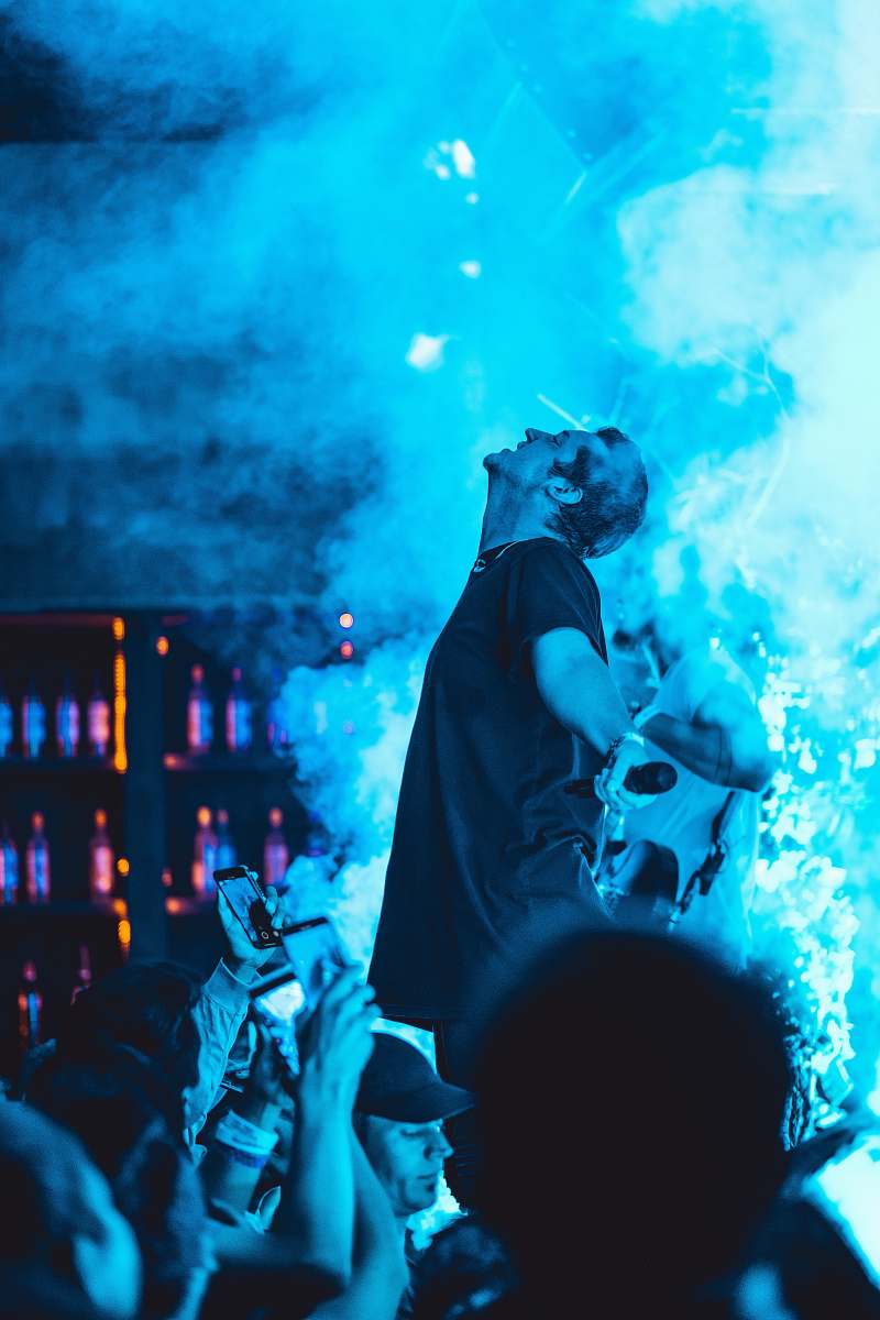 musician man wearing black shirt performing on stage musical instrument