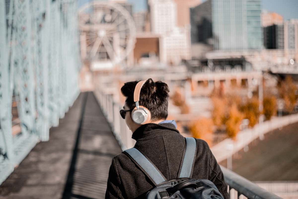 human man wearing brown cordless headphones headphones