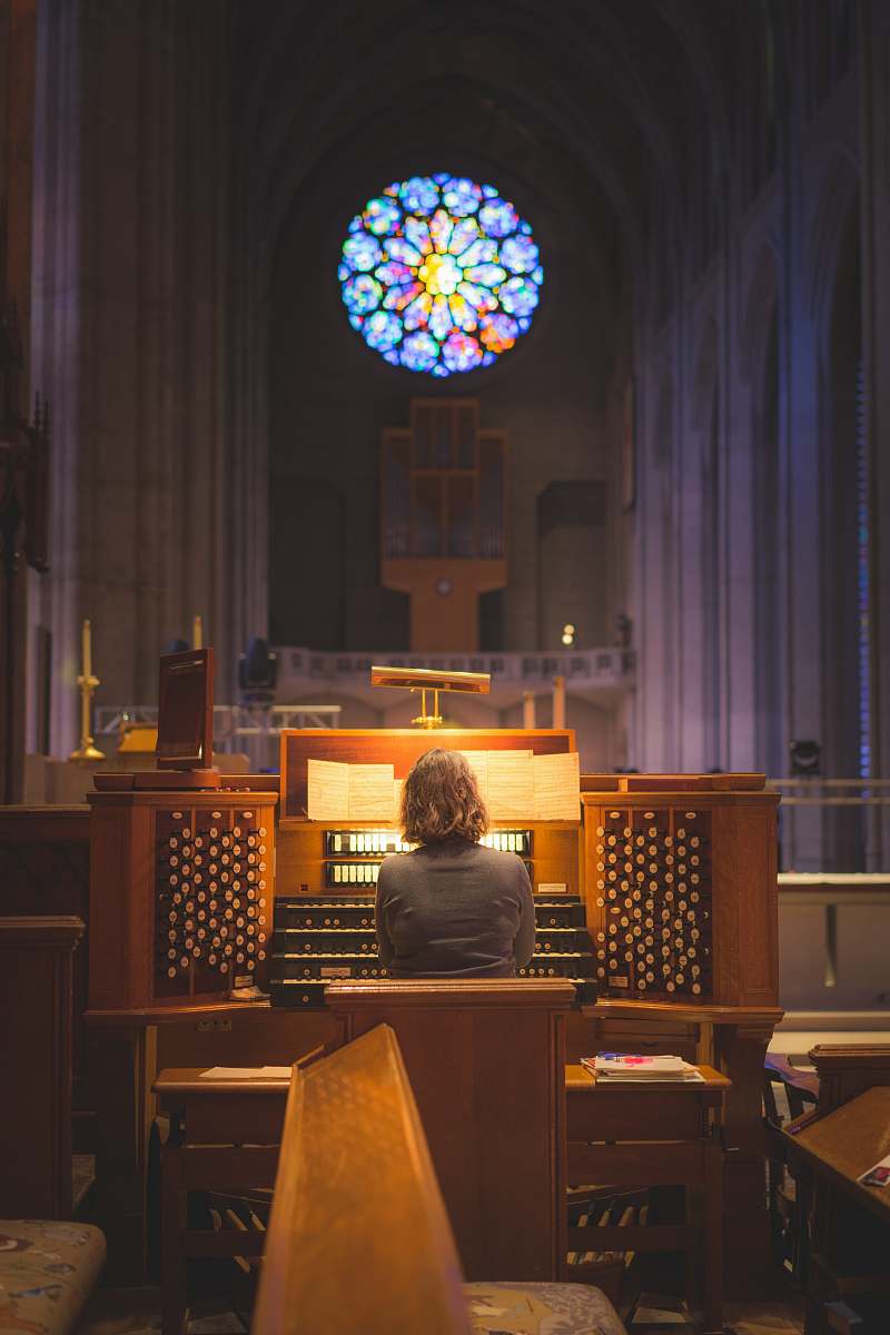 human person sitting in front of church organ people