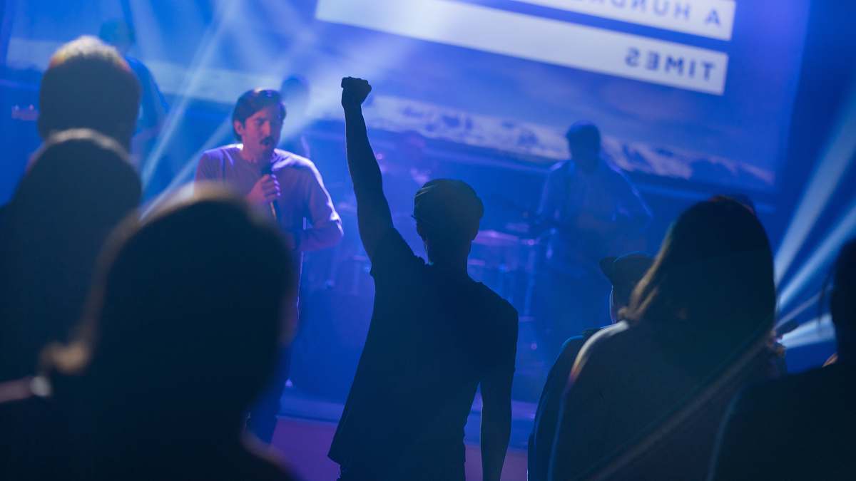 human silhouette of crowd watching performing male band people