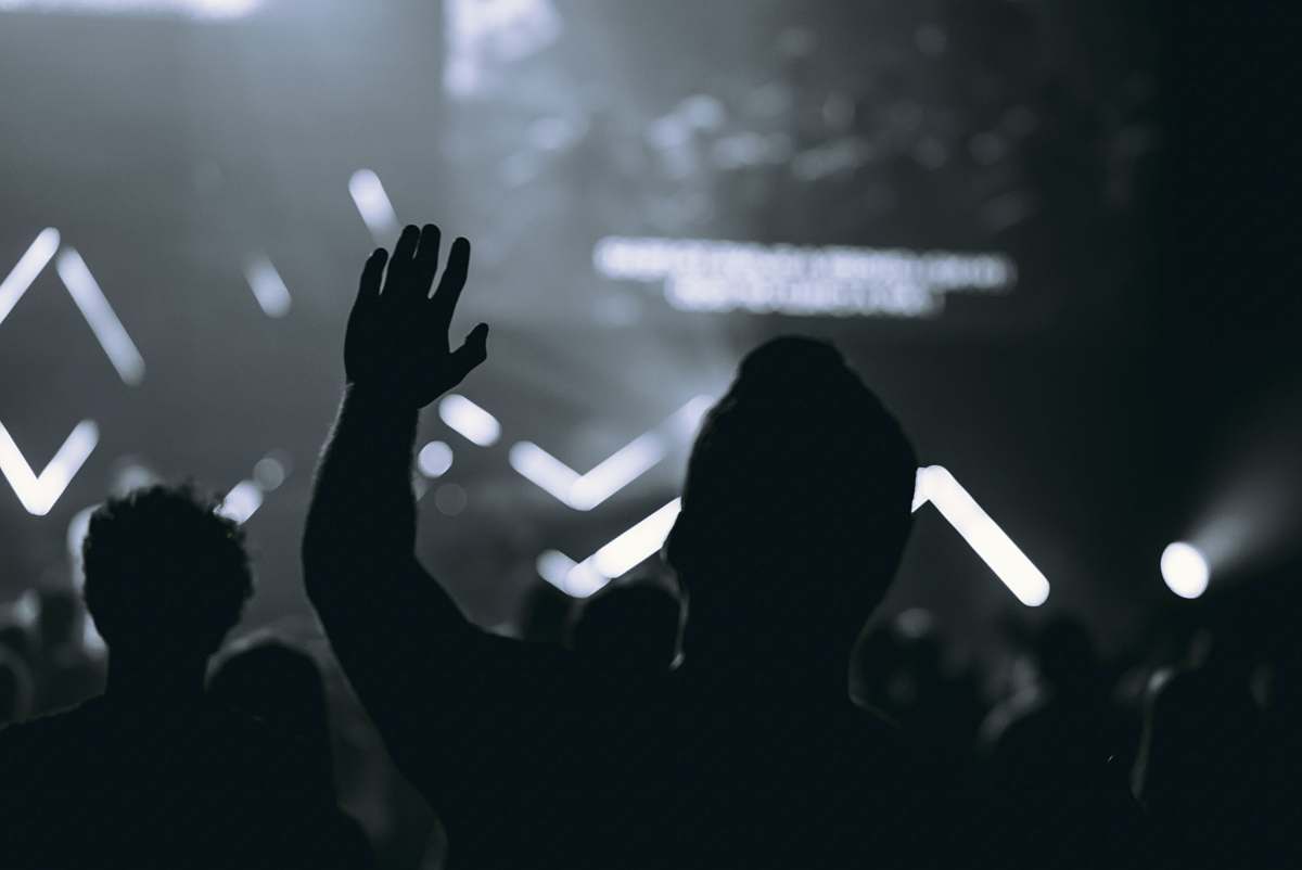 human silhouette of people in front of stage crowd