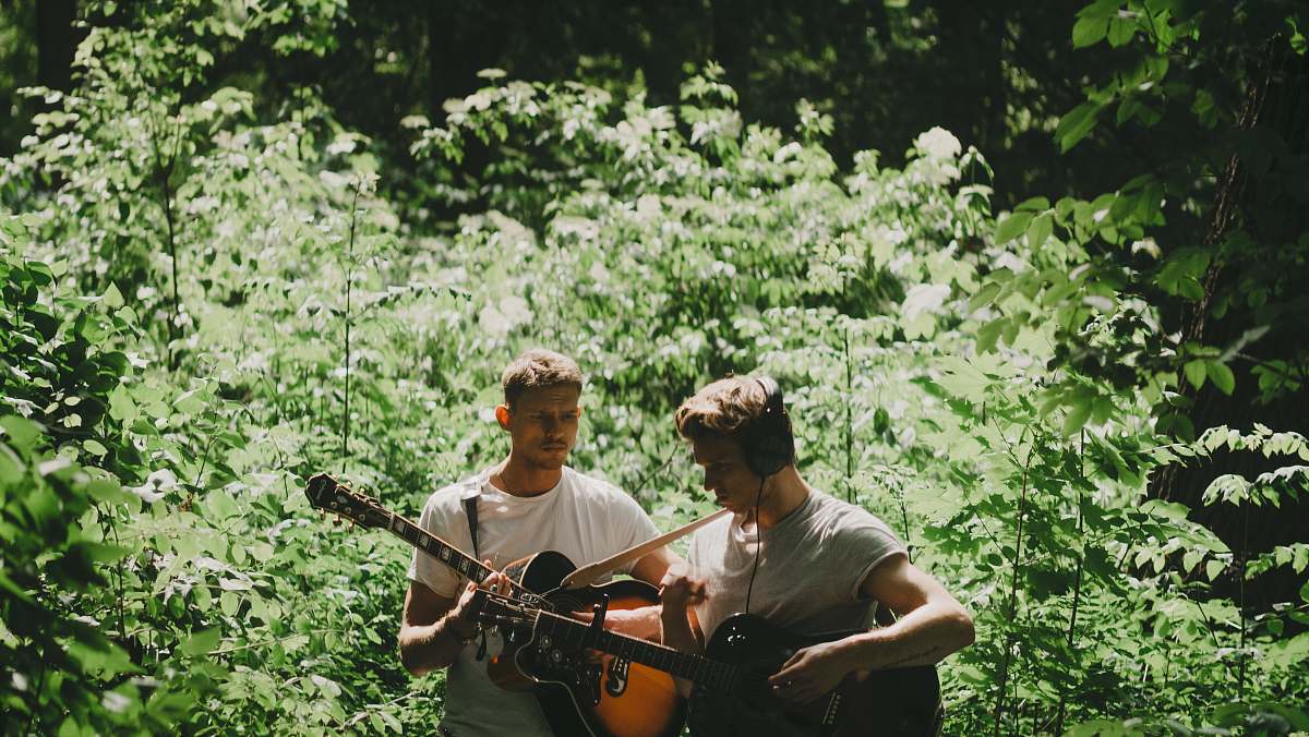 human two men playing guitar people