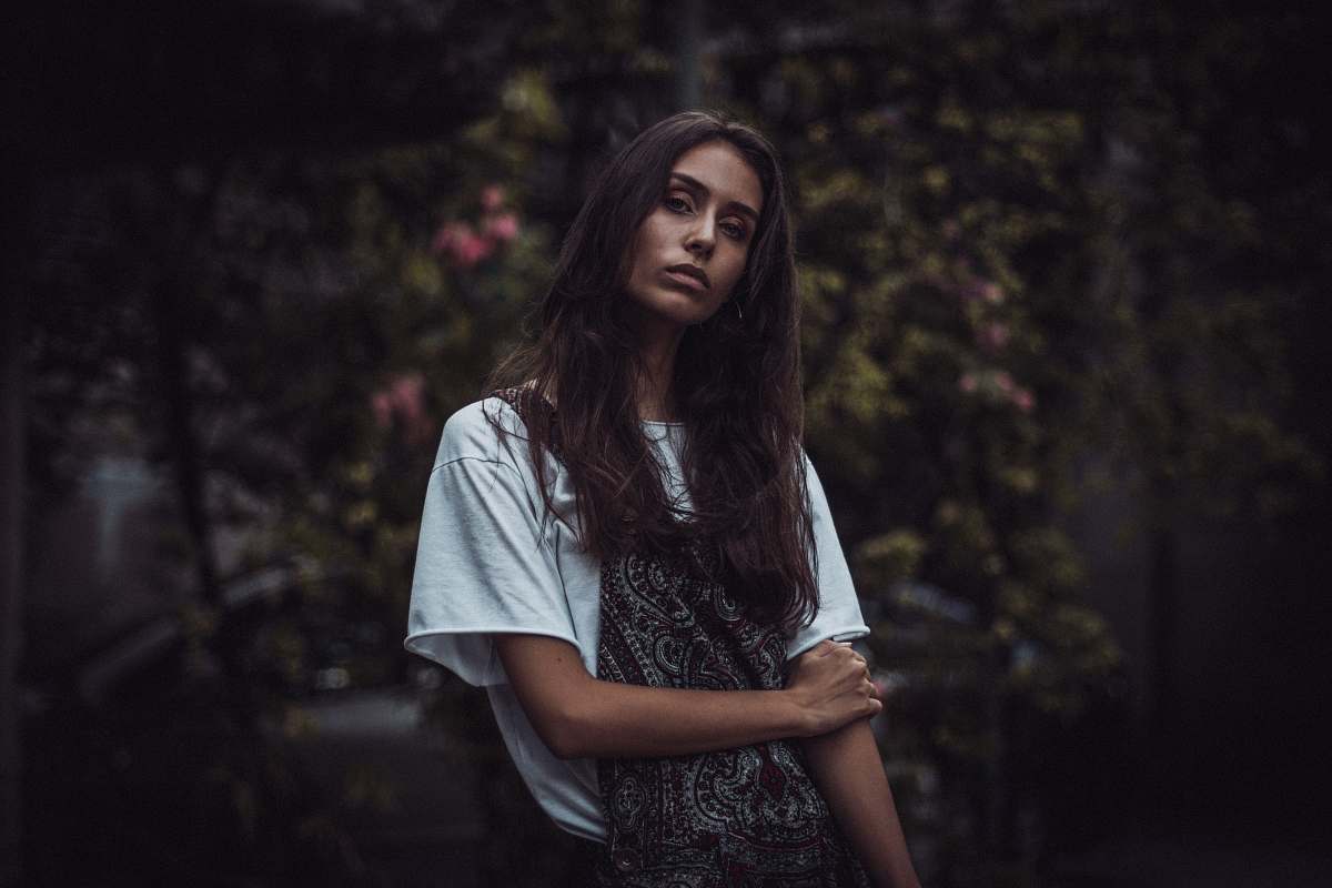 human woman holding her right shoulder while taking selfie people