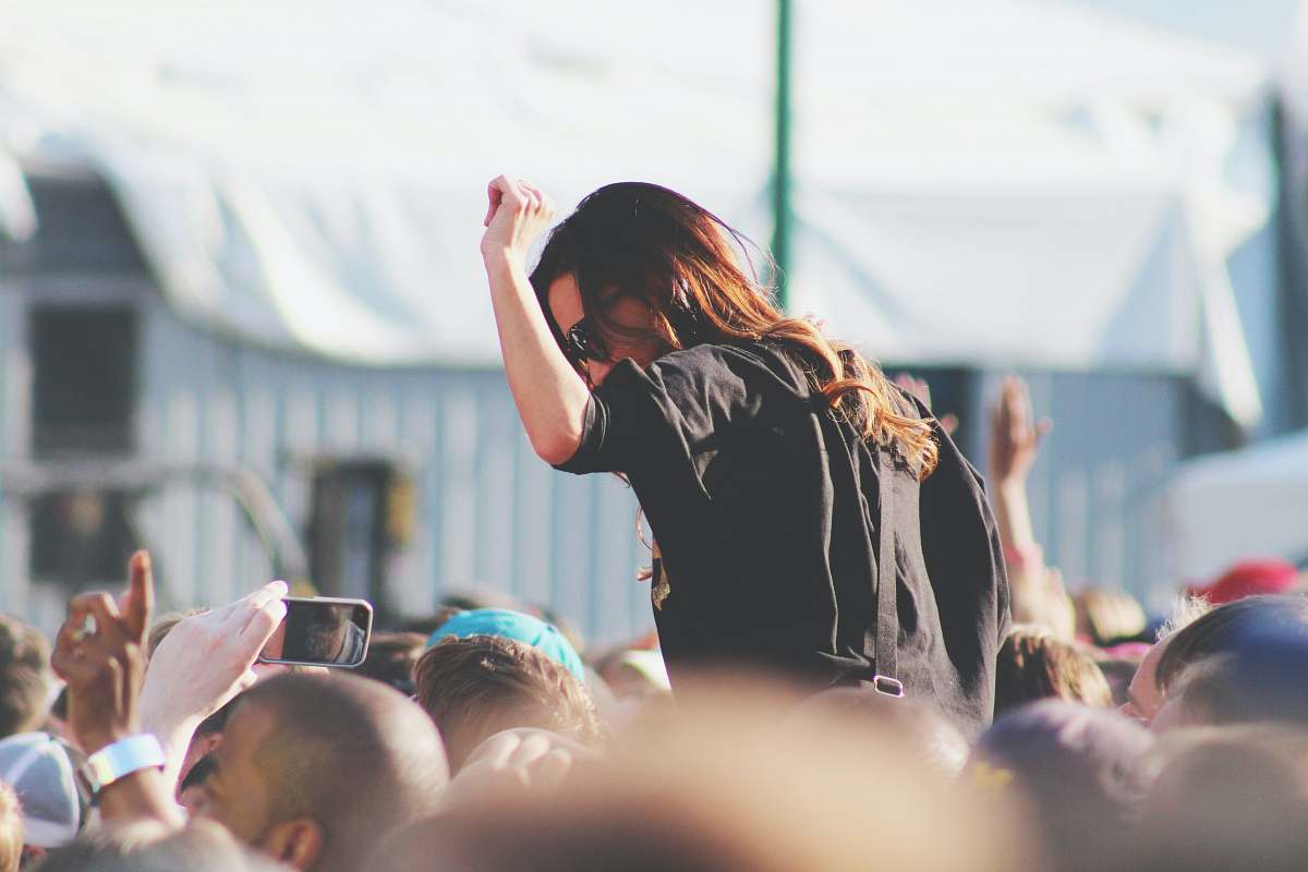 human woman on top of crowd people