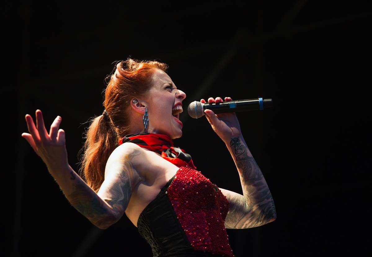 human woman singing on wireless microphone people