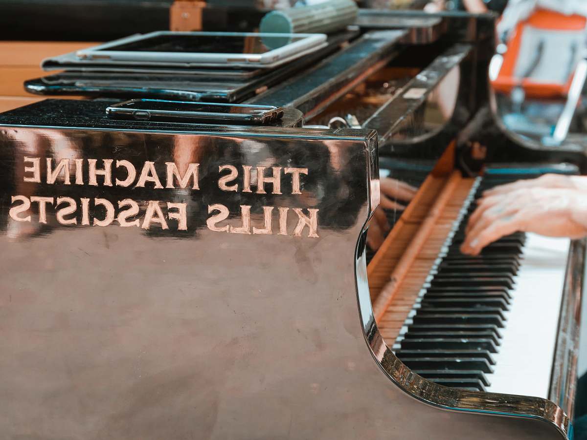 music person using white and black upright piano grand piano