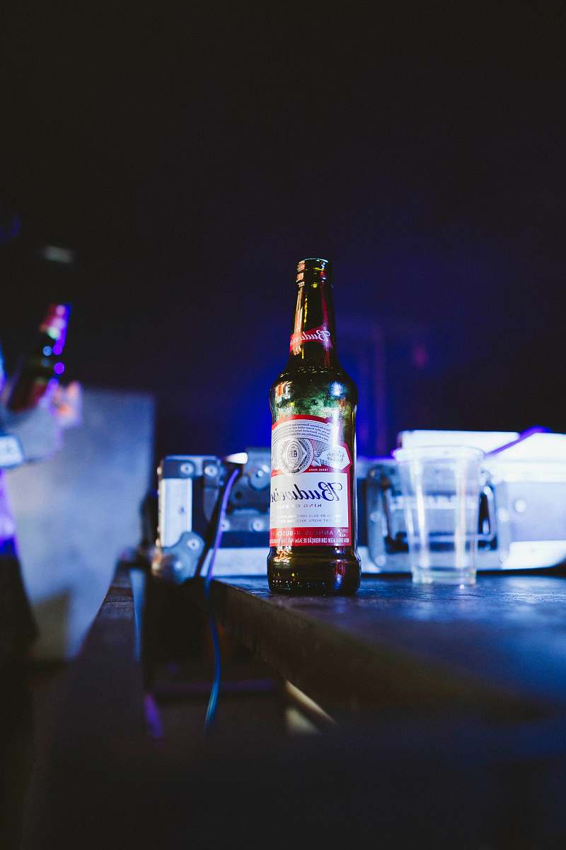 beer Budweiser bottle on brown wooden table alcohol