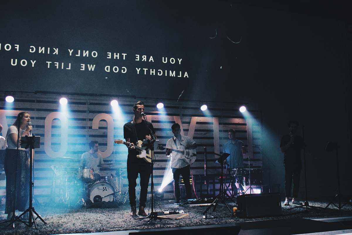 human band playing on stage person