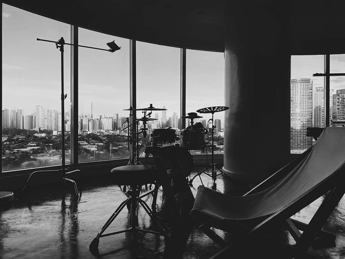 black-and-white grayscale photo of people sitting on chairs near body of water furniture