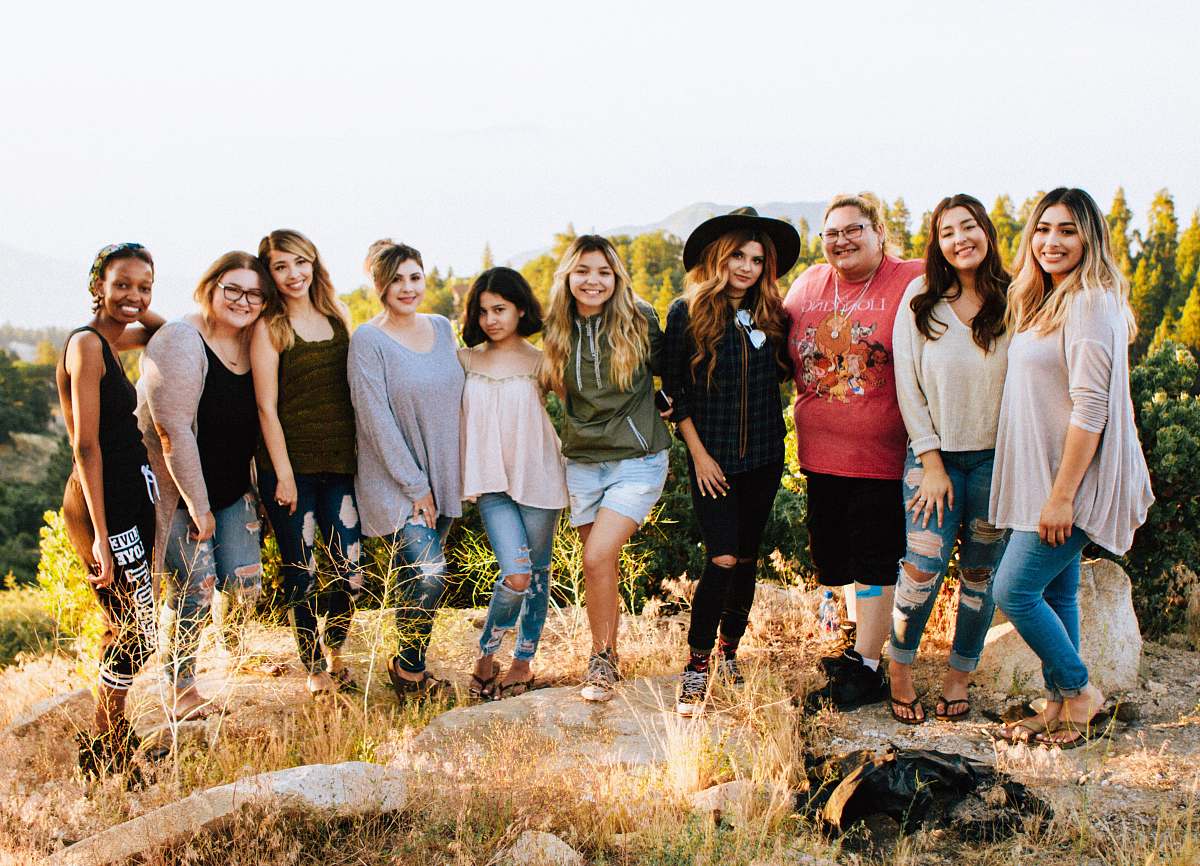 This captivating image features a diverse group of women confidently standing atop a rocky mountain fragment, showcasing their strength and unity in the face of natures grandeur. The breathtaking backdrop of soaring peaks emphasizes their adventurous spirit and determination. This photograph is ideal for projects related to empowerment, outdoor adventures, team building, and diverse representation. Perfect for use in blogs, marketing materials, and social media campaigns that promote inspiration and camaraderie among women.