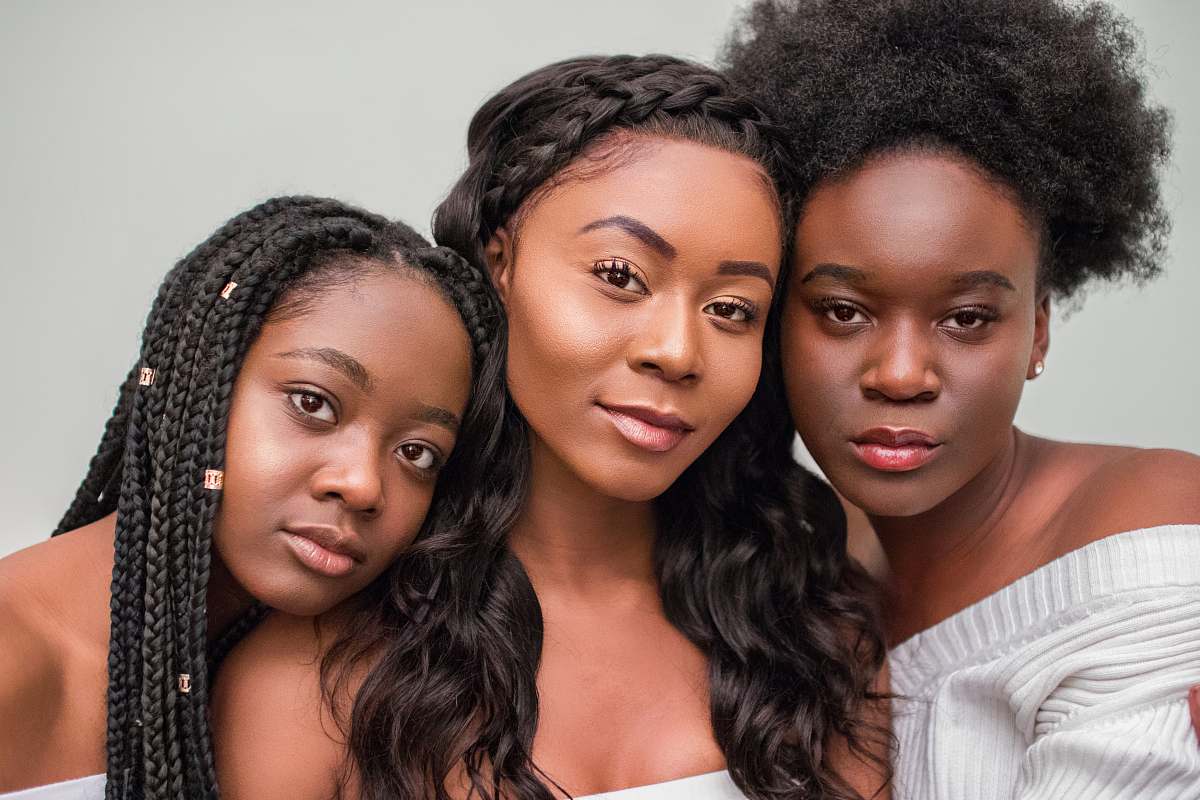  three women taking photo wearing white tops 