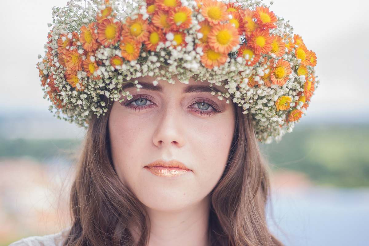  woman with orange and white floral headdress 