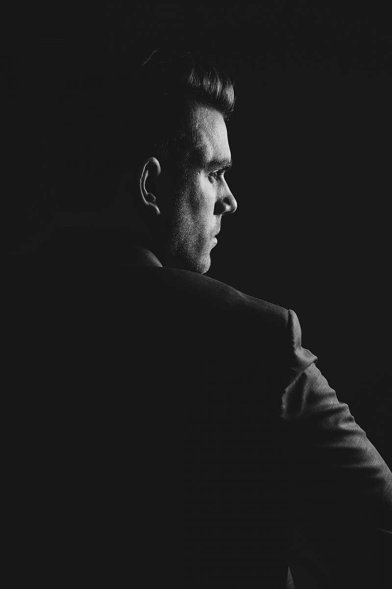 portrait grayscale photo of man wearing blazer person