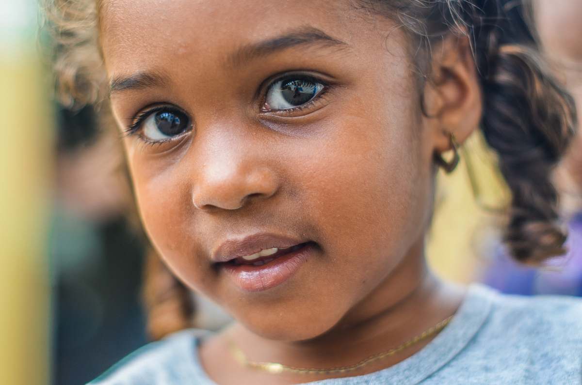 people close-up photography of child wearing gray top kid