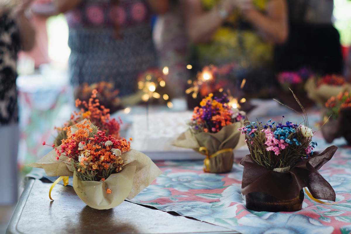 person assorted-color flower decor on table human