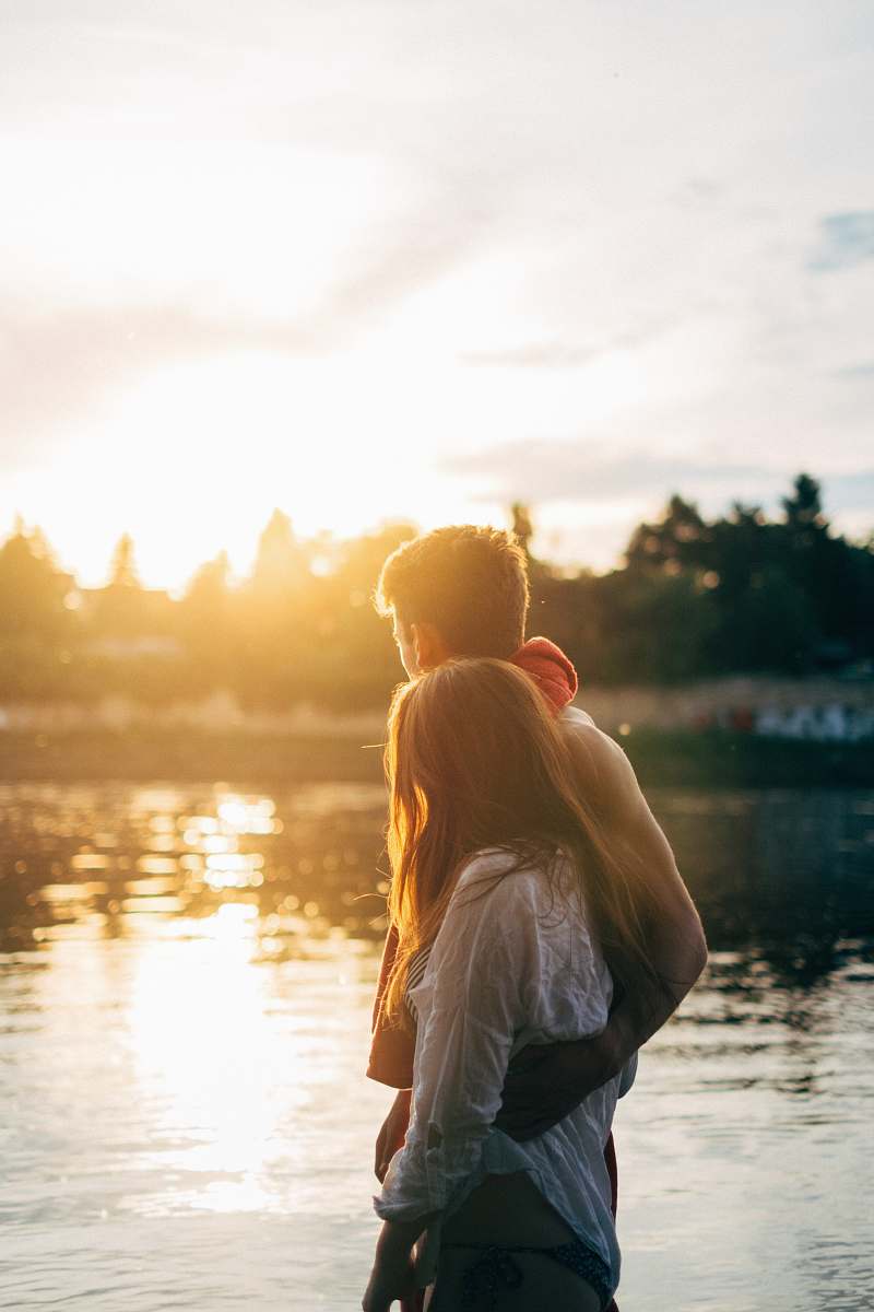 couple couple walking on lake side watching sunset close-up photo summer