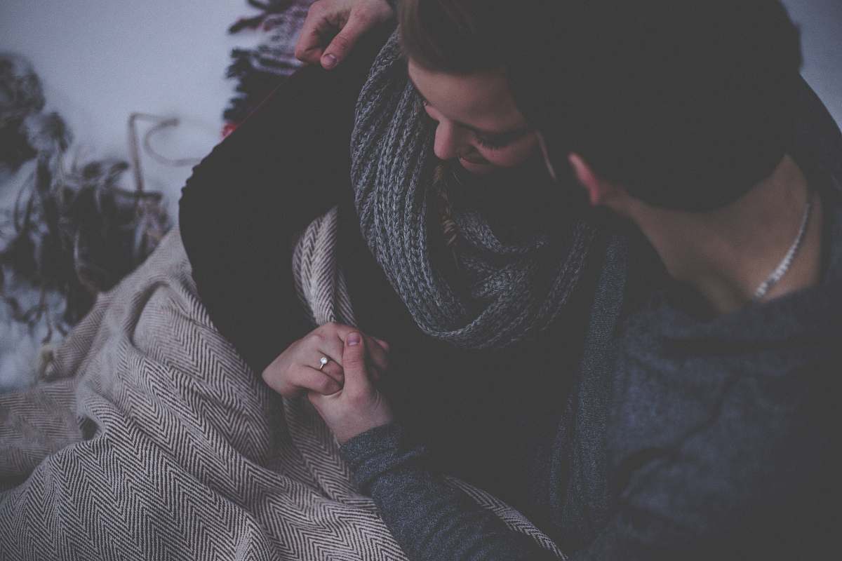 human couple with grey blanket couple