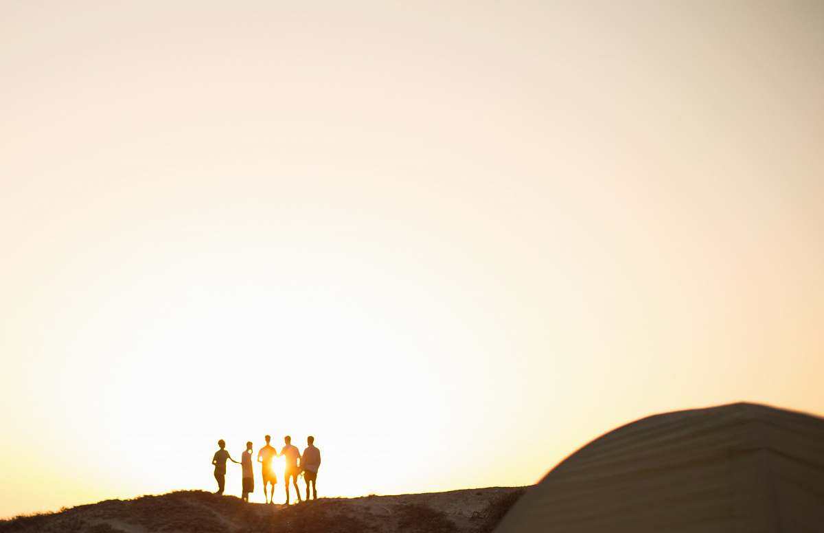 silhouette five men standing on a cliff group