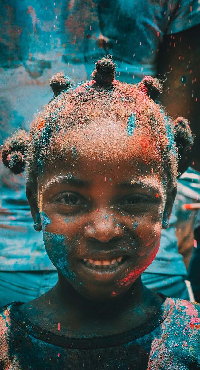 person girl covered with holi powder during daytime human