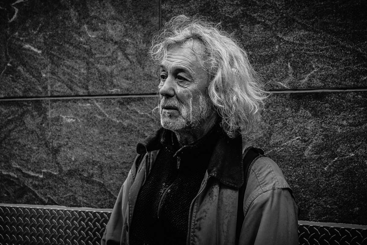 black-and-white grayscale photo of long-haired man grey
