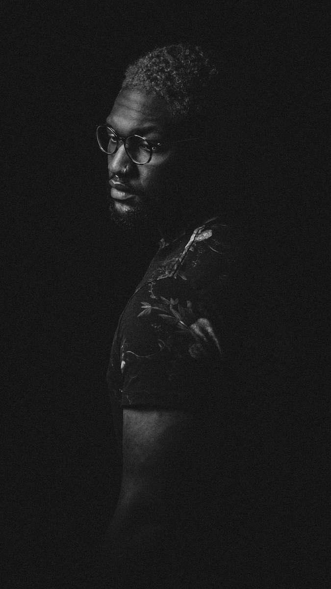 black-and-white grayscale photo of man in eyeglasses black