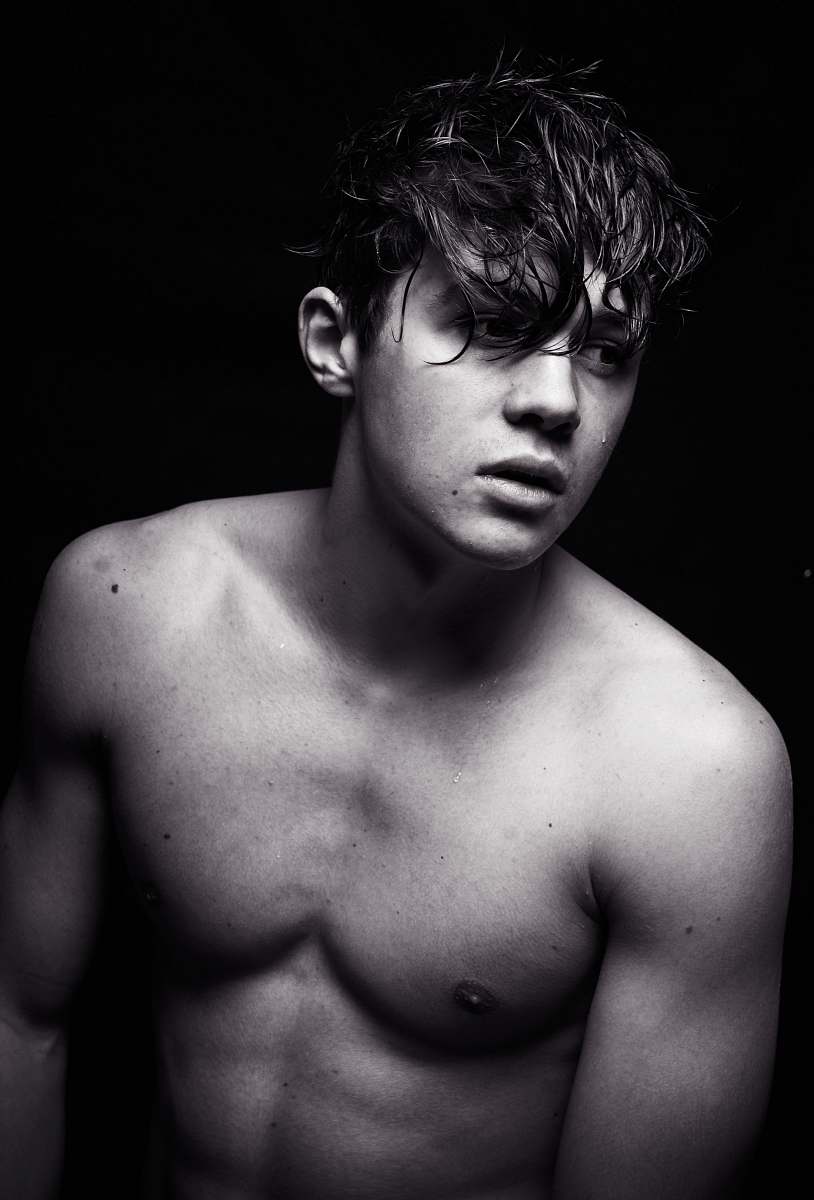 male grayscale photo of topless man man