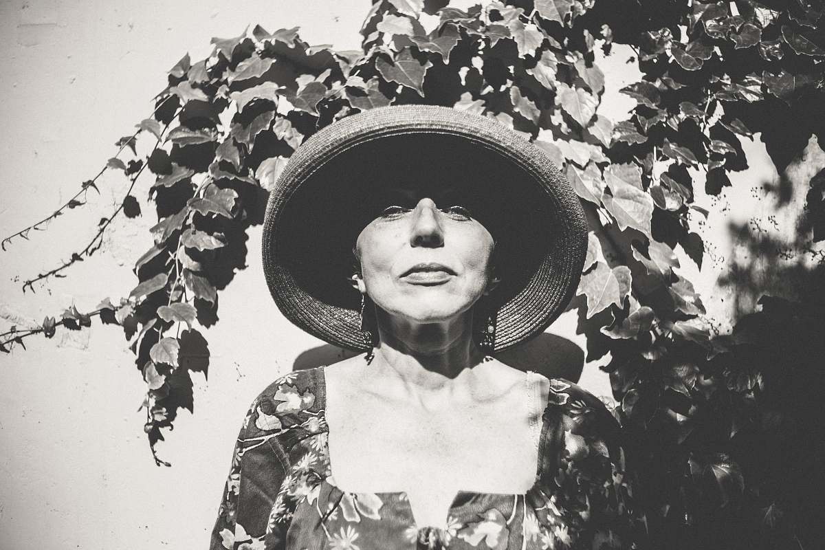 person grayscale photo of woman wearing hat hat