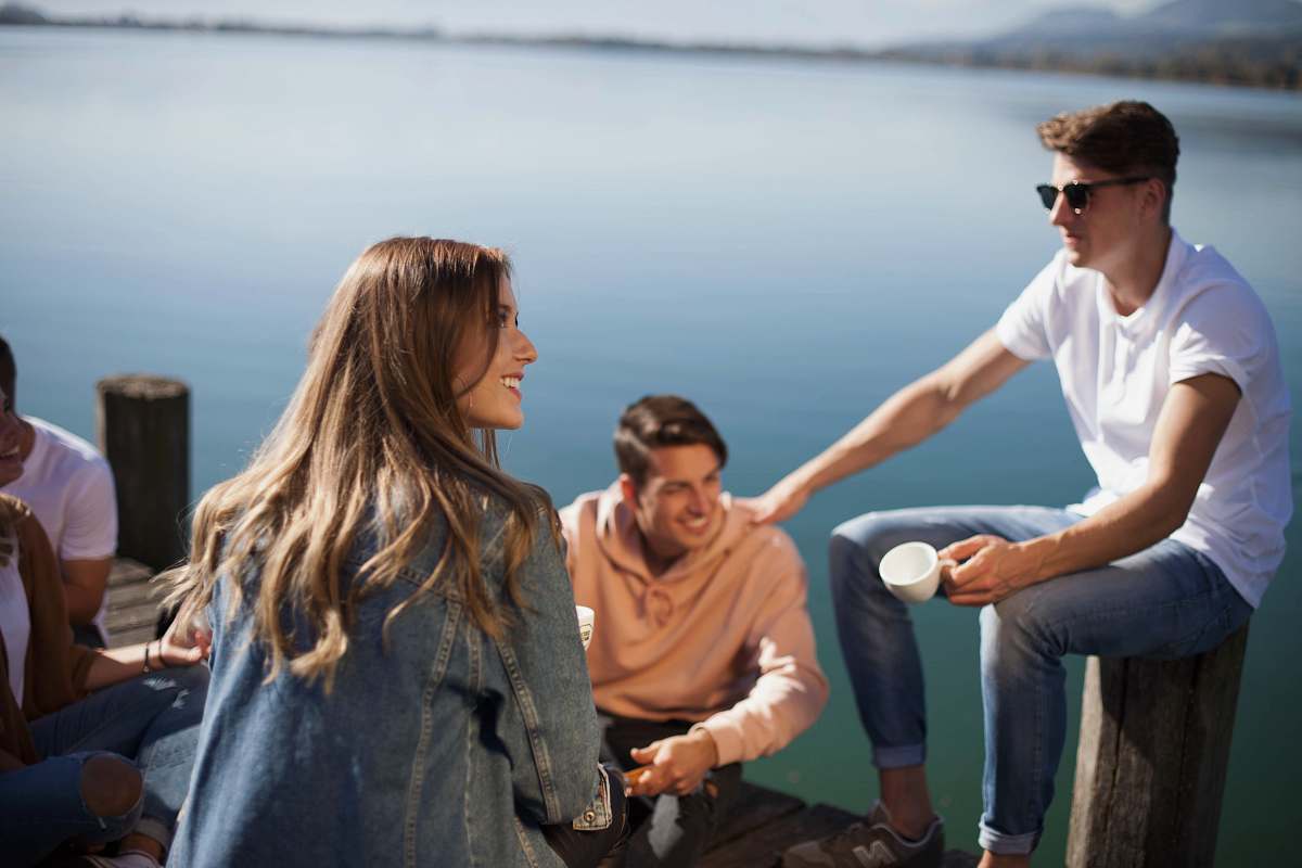 person group of people sitting on boat dock human