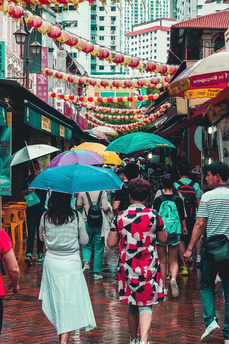 umbrella group of people walking at street with bazaar singapore