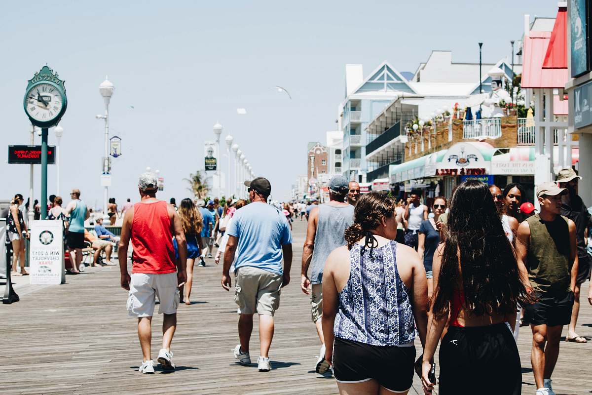 boardwalk group of people walking on street during daytime tourist