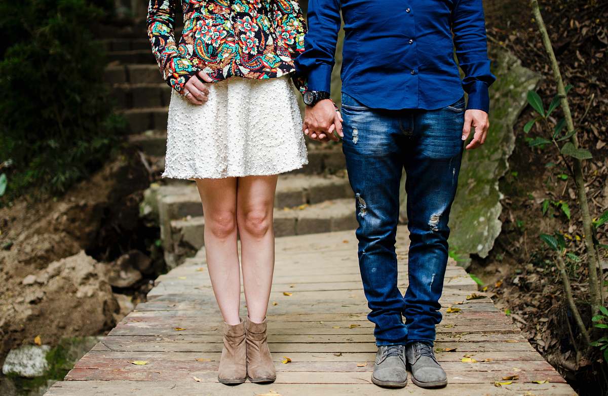 couple man and woman holding hands during daytime clothing