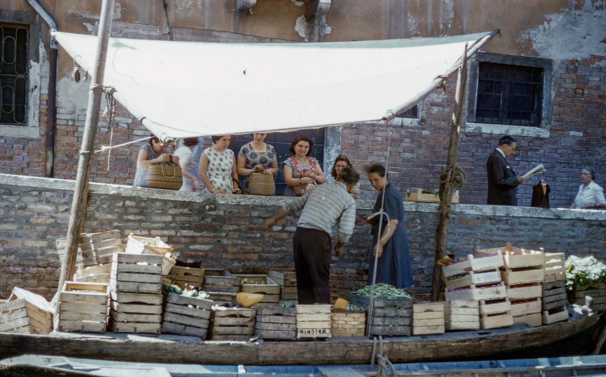 person man and woman on boat selling fruits in crate human