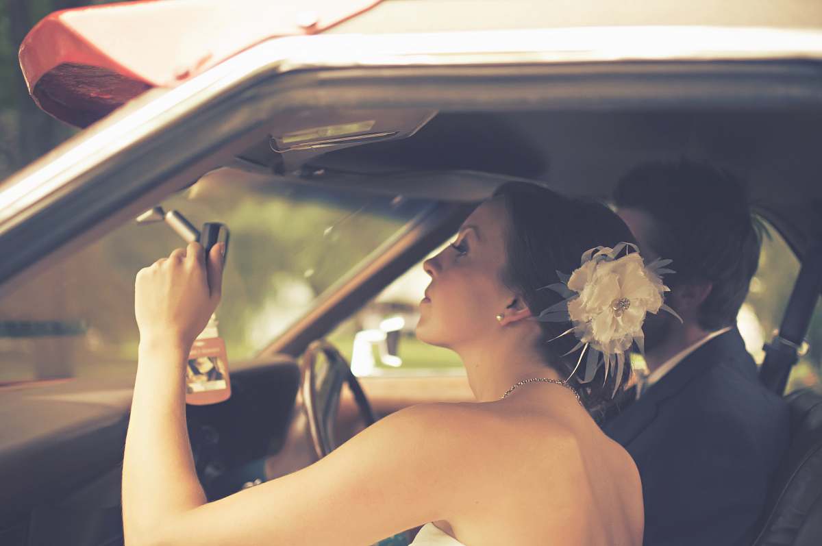 person man and woman sitting inside the vehicle wedding