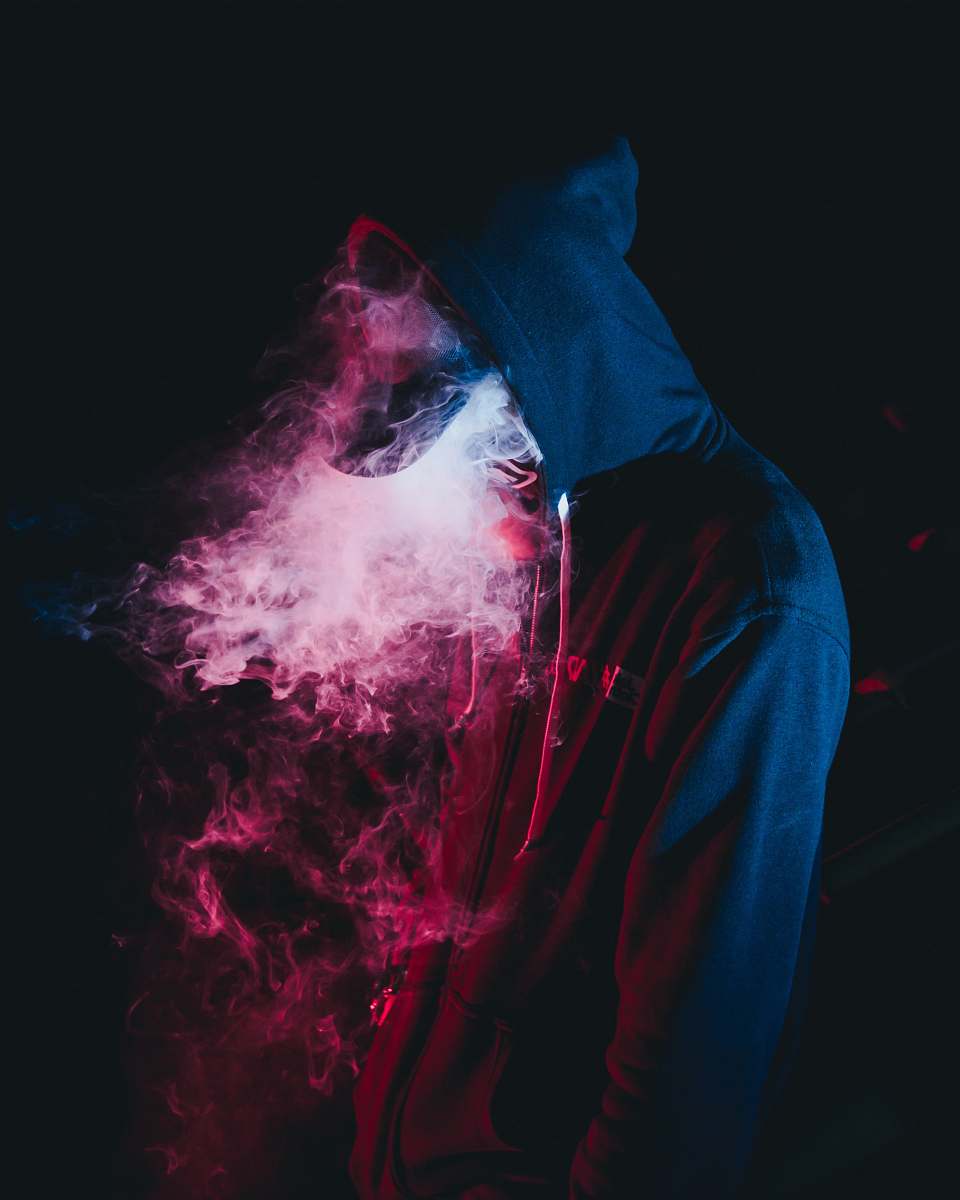 person man in black hoodie smoking smoke