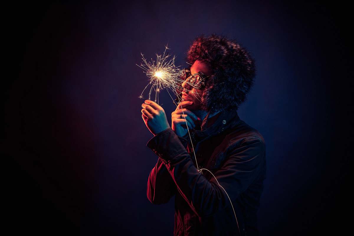 sparkler man in black jacket holding spark man