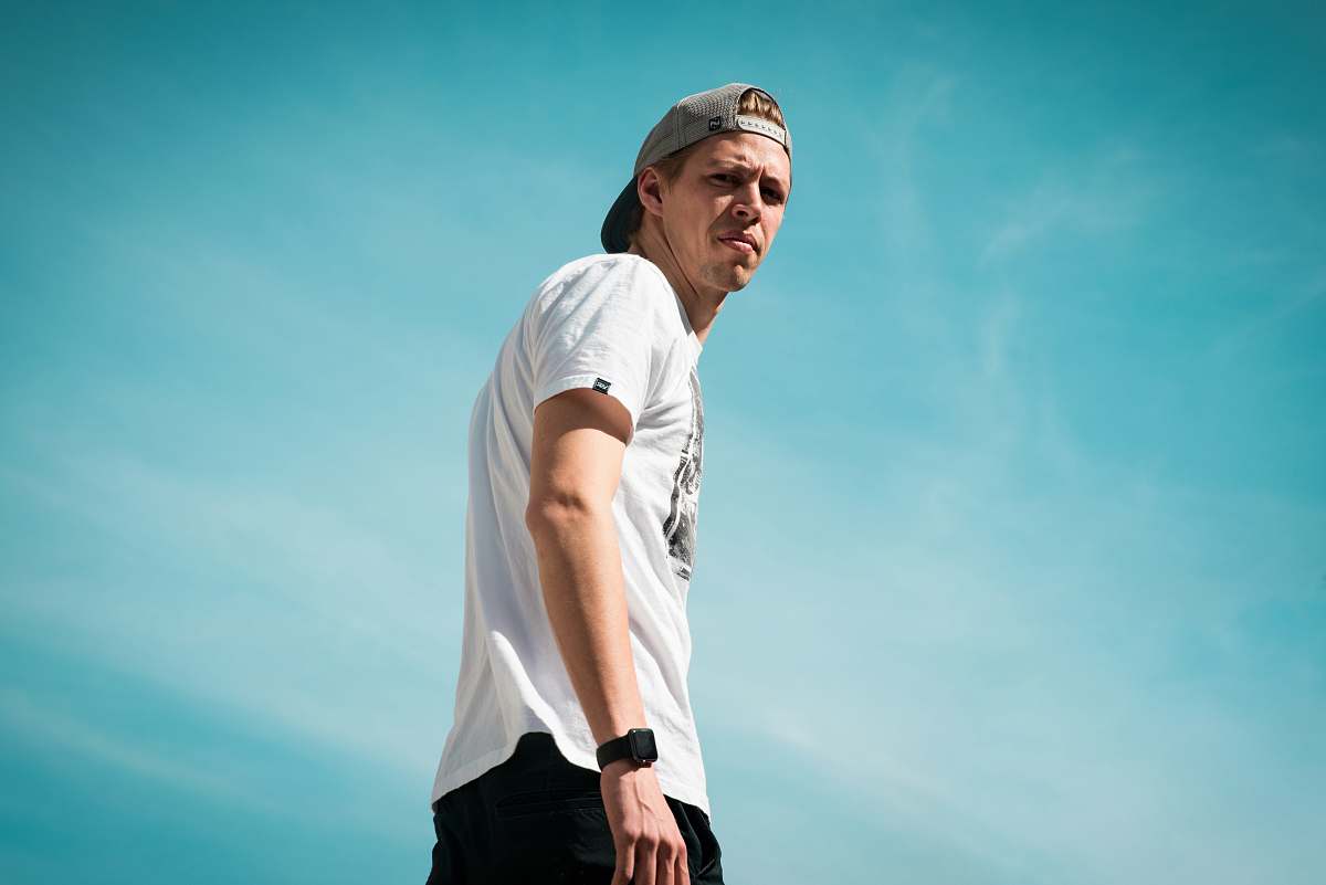 person man in white crew-neck T-shirt blue