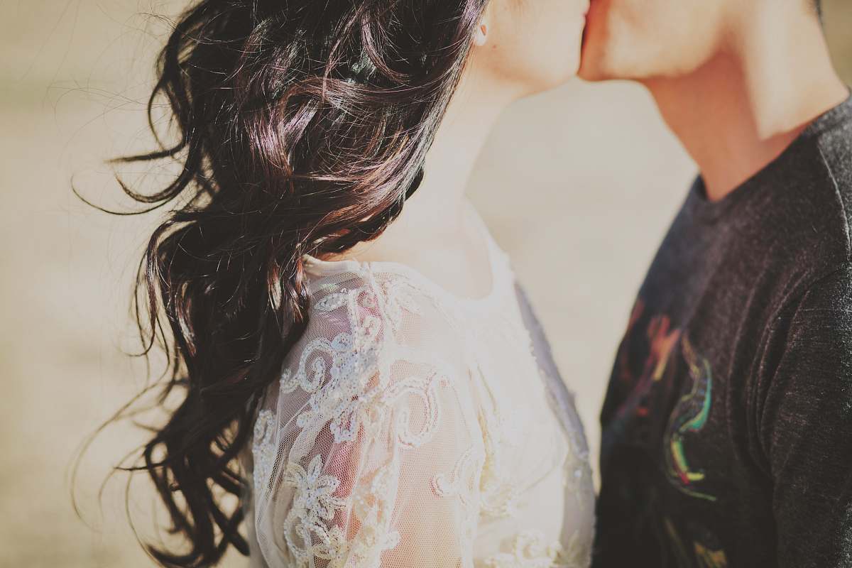 person man kissing woman love