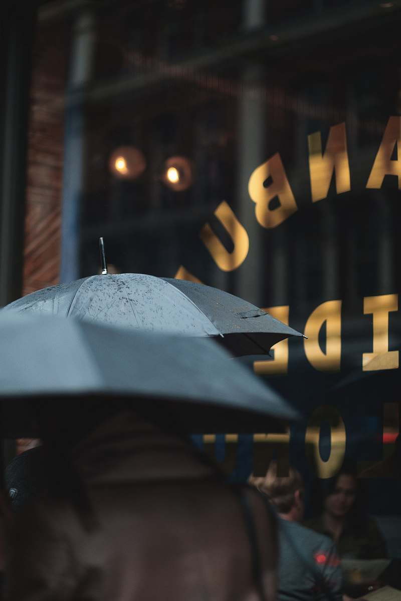 person man on blue umbrella london
