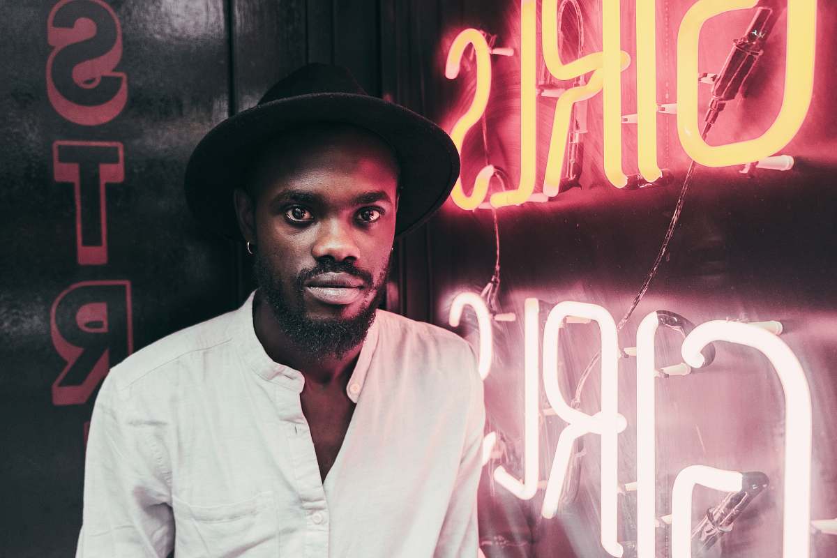 man man standing beside LED signage african american